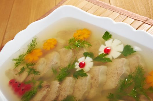 Aspic from meat decorated with egg, carrot,