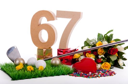Roses, a golf club and golf balls on an artificial peace of grass to be used as a birthday card