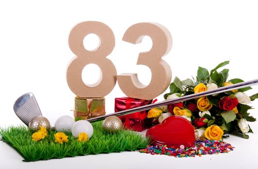 Roses, a golf club and golf balls on an artificial peace of grass to be used as a birthday card