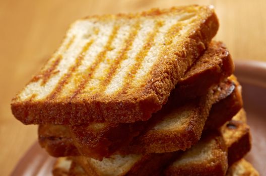 pile  toasted bread slices for breakfast.Close up of toasted white bread in slices