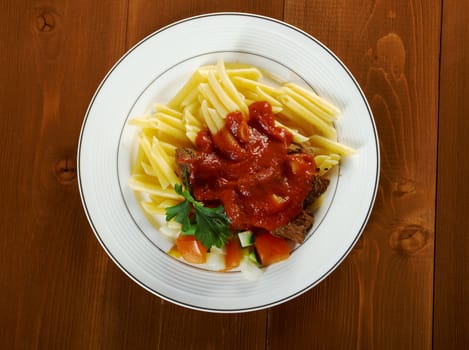  pasta with tomato beef sauce  on wooden table