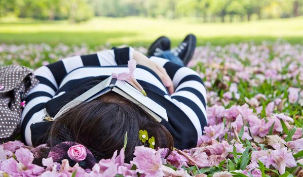 Asian woman sleeping on the grass