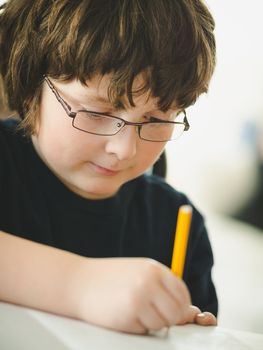 Cute little boy doing his homework