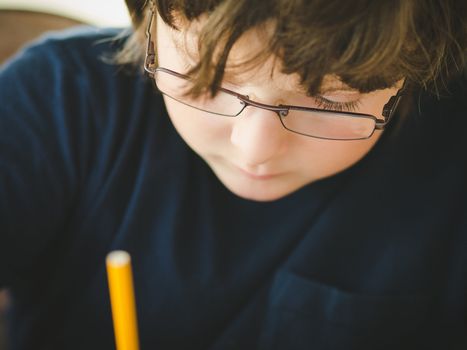 Cute little boy doing his homework