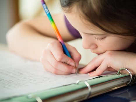 Cute little girl doing her homework