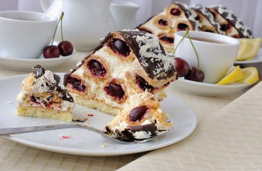 piece of cake with cherries in chocolate with coconut