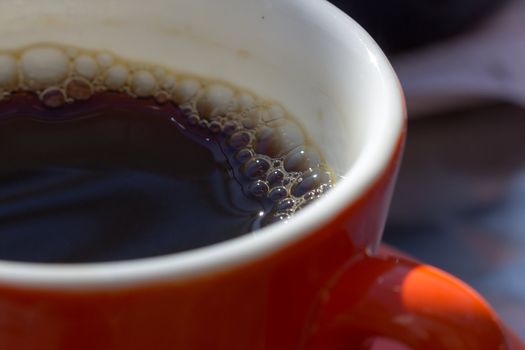 Picture of a red mug of black coffee