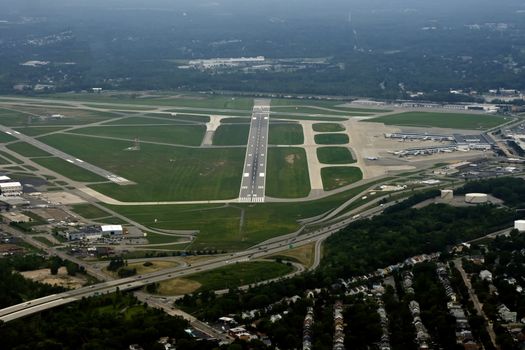 Ariel view of a runway of a medium sized US airport as viewed from the cockppit of an approaching airliner