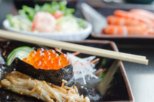 Salmon roe sushi  with vegetable on dish