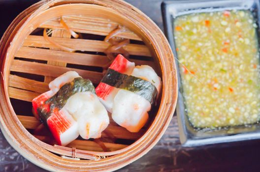 Chinese steamed dim sum crab in bamboo containers traditional cuisine , served with spicy sauce