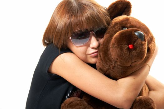 The girl with the teddy bear on a white background 