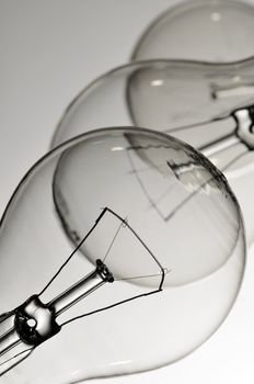 Close-up of three lightbulbs isolated over white