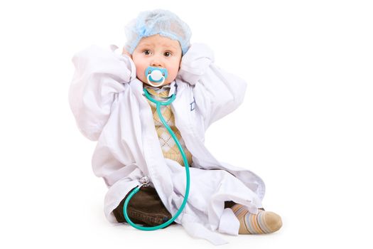 boy of one year old in gown of doctor with stethoscope
