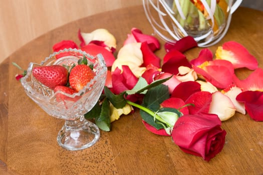 beautiful red tulip petales ans strawberry in bowl on the table