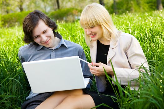 businessman and girl laugh looking at laptop
