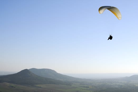 Paraglider flying over the Hungarian countryside