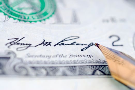 Handwriting banknote. Signing a dollar black ink