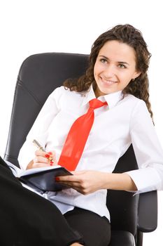 businesswoman in armchair with pen and book