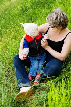 small girl on the grass with grandmother