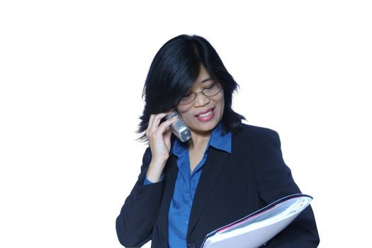 Asian business woman making a call while holding folder.