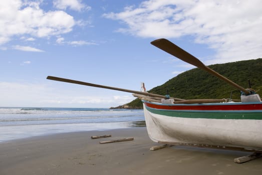 Deserted beach with empty fishing boats in the sand.