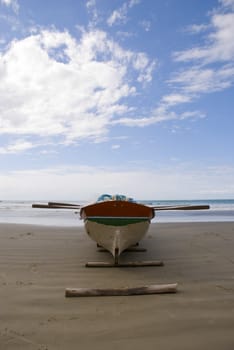 Deserted beach with empty fishing boats in the sand.