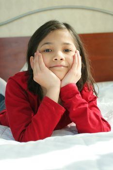 Child lying on bed thinking