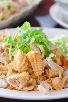 fried squids and  garlic served with vegetable on white dish