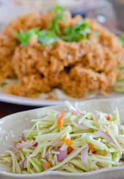green mango salad  and vegetable served with crispy catfish , spicy and sour