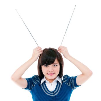 Portrait of an attractive young Asian  female holding antennas on head over white background