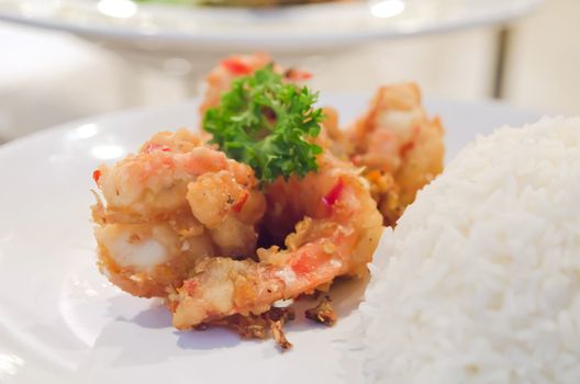 close up deep fried shrimp with chili sauce , served with steamed rice , spicy seafood