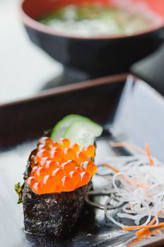 Ikura Sushi with cucumber and fresh vegetable on dish