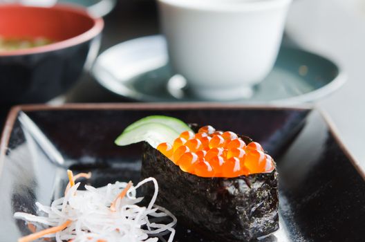 close up Ikura Sushi and slices daikon radishes