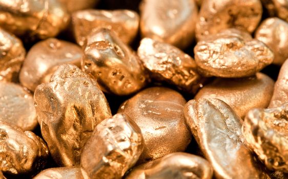 shiny gold nuggets background. closeup.