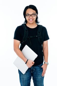 Handsome young male student holding a laptop.