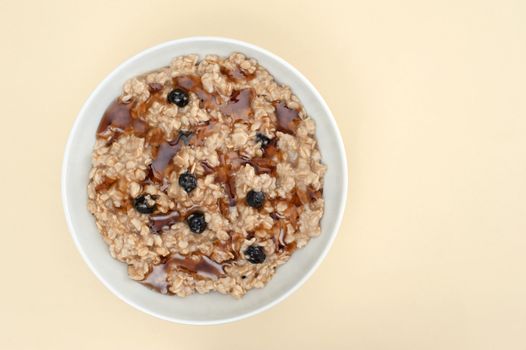 Overhead view of a bowl of maple raisin oatmeal.