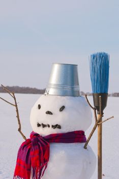 Lonely snowman at a snowy field at winter time