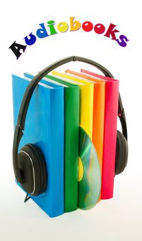 Row of books and headphones on the reflective surface over white background