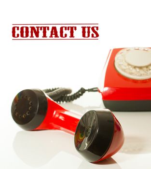 Red old fashioned handset and telephone - Contact us concept