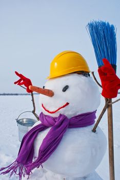 Lonely snowman at a snowy field at winter time