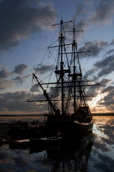 Vintage 18th century sailboat docked in the harbour at sunset in Nova Scotia