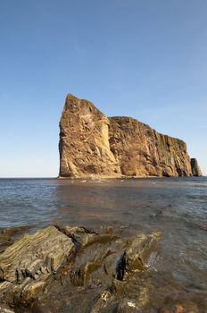 Perce Rock with copy space in the intense blue sky and rock formation in the foreground