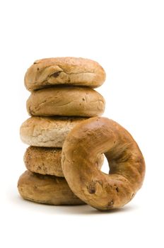 Cinnamon bagel resting against a stack of bagels