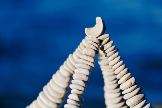 Balancing of white stones on the top of pyramidal stack