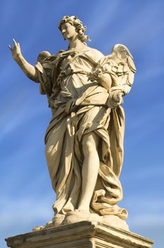 a statue of an angel standing on the bridge leading to the Castle Sant'Angelo, Rome