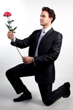 Portrait of a young successful businessman with a flower in your hand