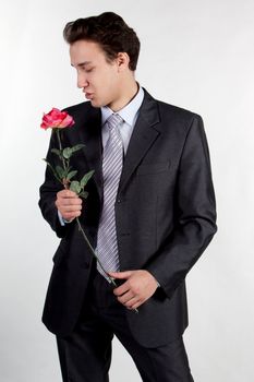 Portrait of a young successful businessman with a flower in your hand