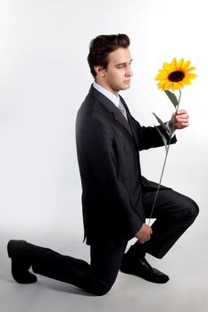 Portrait of a young successful businessman with a flower in your hand