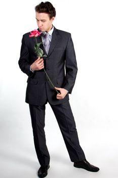 Portrait of a young successful businessman with a flower in your hand