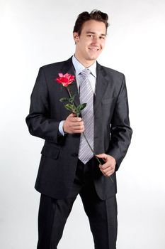 Portrait of a young successful businessman with a flower in your hand